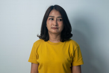Asian women standing wearing yellow shirts emotional face and feeling grumpy frowning eyes brows...