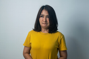 Asian women standing wearing yellow shirts emotional face and feeling grumpy frowning eyes brows...