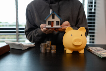 a man uses his savings to buy his dream home, this man plans his finances to buy a home, he uses...