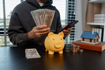 a man uses his savings to buy his dream home, this man plans his finances to buy a home, he uses...