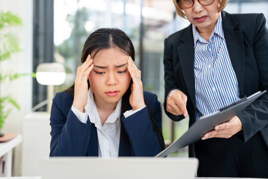 strict boss woman swearing at depressed employee woman for bad work at the workplace looking angry