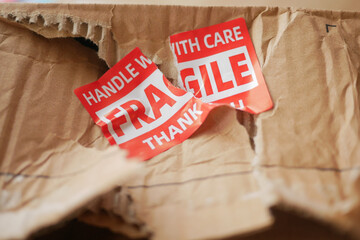 Delivery box damaged with fragile stickers at home
