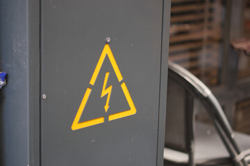 Warning sign on electrical cabinet in industrial location