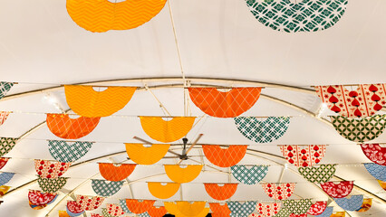 Brightly colored festive decorations adorn an indoor space for celebration event
