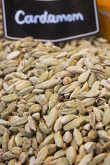 Cardamom pods displayed at a vibrant market stall