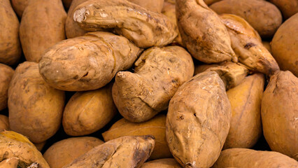 Close-up Photo of a Pile of Yellow Sweet Potatoes Showing Off Fresh Market Produce