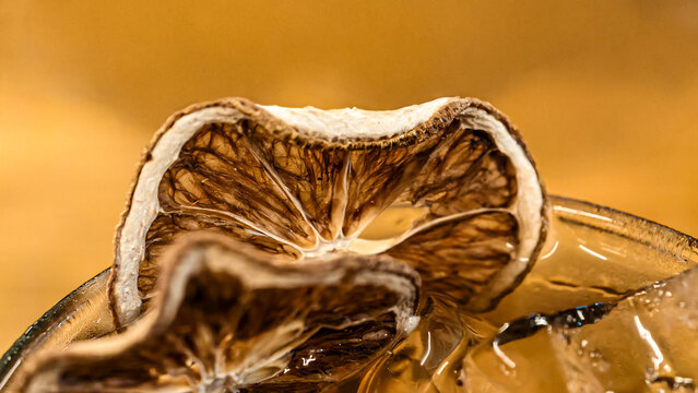 Refreshing beverage with dried citrus garnish served in a stylish glass
