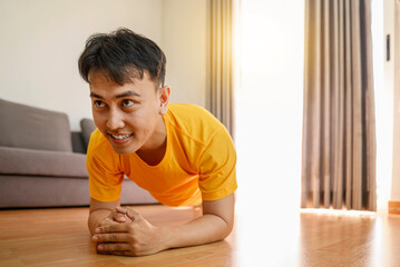 Indonesian southeast asian man stretching his leg before a workout at home for a healthy lifestyle and body care. Fitness and active lifestyles concept