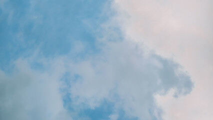 Serene skyscape capturing the ethereal beauty of soft clouds against a blue backdrop