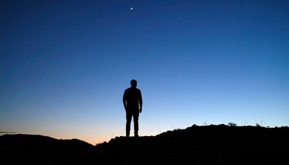 Silhouette Of Person On Hilltop At Twilight