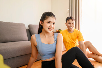Indonesian southeast asian couple stretching before a workout at home for a healthy lifestyle and body care. Fitness and active lifestyles concept