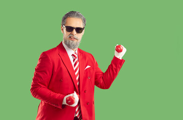 Merry Christmas. Funny, modern Santa Claus in stylish red suit and striped tie holds dumbbells,...