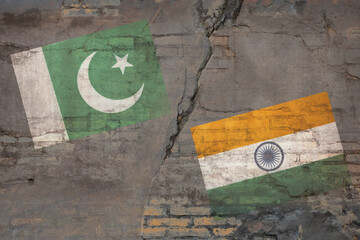 India and Pakistan flags on the brick wall. Pakistan vs India military war conflict. Weapon of a nuclear missile battle