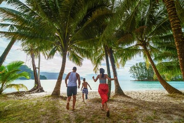 family running on the beach on Ko Kood island