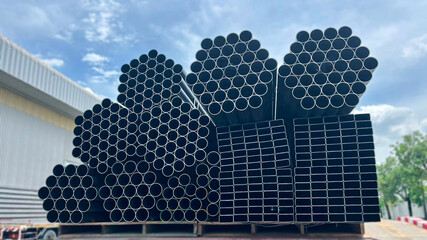 Square steel tubes aligned in a bundle, ready for use in building structures and industrial...