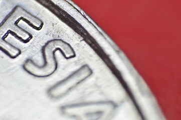The embossed lettering stands out sharply, with a metallic sheen that highlights the precision of...