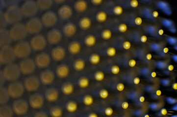 A highly detailed macro shot of golden pins on a computer processor, showcasing the dense array of...