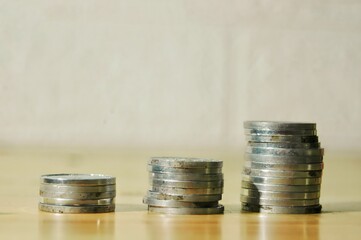 A macro image of several stacks of silver coins placed in ascending order