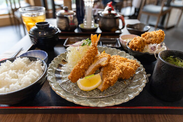 Fried Japanese Tonkatsu Pork and Shrimp cutlet serve with a slice of lemon and cabbage. 