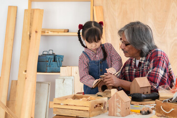Carpenter family lifestyle activities concept, happy old age grandpa carpentry owner spends time...