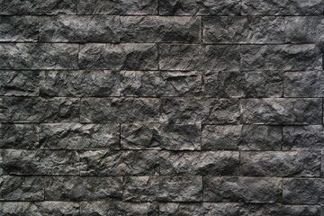 a textured stone wall with rough surfaces and varying gray tones, perfect for use as a background or in architectural and design projects