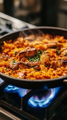 mini paella in portable cazuela over gas burner.