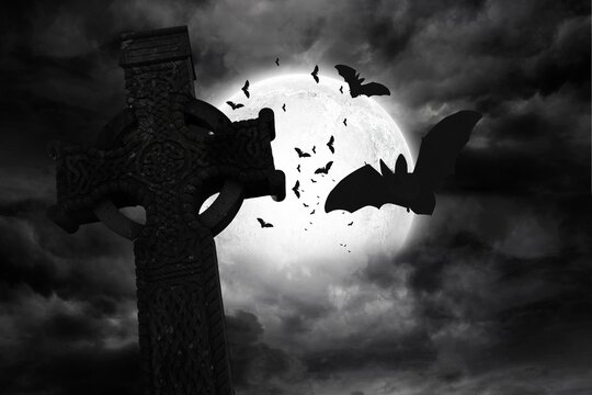 Fototapeta Digital image of bats flying by celtic cross