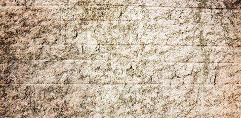 Fototapeta premium Rough weathered stone wall texture is being shown in flat design, showcasing layered cracks