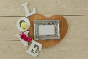 Photo frame with love alphabet on table