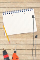 Tools and notepad on wooden background