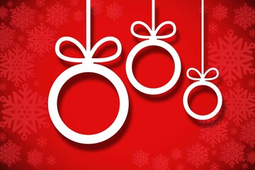 Hanging christmas decorations on red