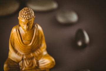 Wooden Buddha statue by stones