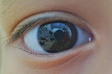 Macro shot of a human eye, capturing the intricate details of the iris, eyelashes, and a reflection...