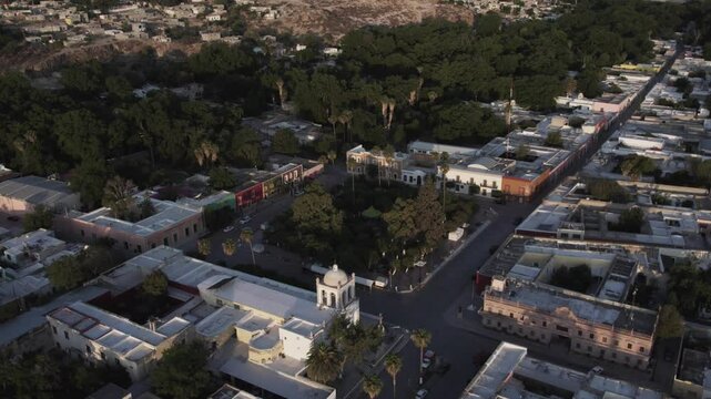 Drone footage at sunrise over Parras de la Fuente, showing urban layout and surrounding terrain under clear sky conditions, captured in stable 4K resolution with smooth tracking and overhead shots.
