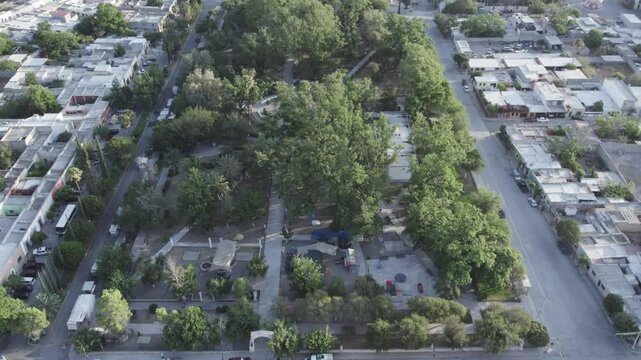 Drone footage at sunrise over Parras de la Fuente, showing urban layout and surrounding terrain under clear sky conditions, captured in stable 4K resolution with smooth tracking and overhead shots.
