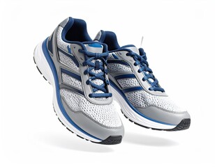 Pair of gray and blue running shoes on a white backdrop