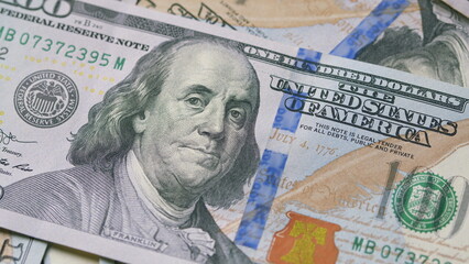 Closeup of U.S. Hundred Dollar Bills showcasing their design, texture, and significance