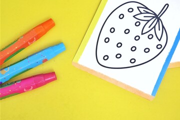 Colorful Crayons and Strawberry Coloring Card on Sunny Yellow Background