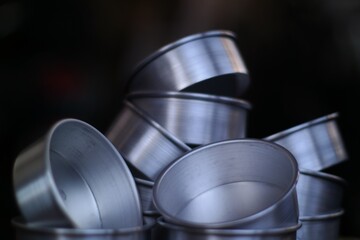 Stacked Silver Cake Pans Abstract Culinary Still Life with Dark Background