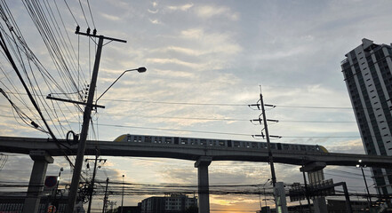 Urban metro train on elevated track at sunset, Metropolitan Rapid Transit Nakkhara Phiphat Line, Bangkok, Thailand - 25 June 2025