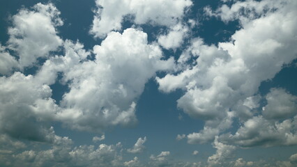 Time lapse. Dynamic Cloud Patterns Gracefully Floating Under a Bright and Beautiful Blue Sky Above