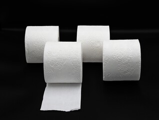 Stack of White Toilet Paper Rolls on Dark Surface – Clean and Minimal Style. Hygiene and Supply Concept