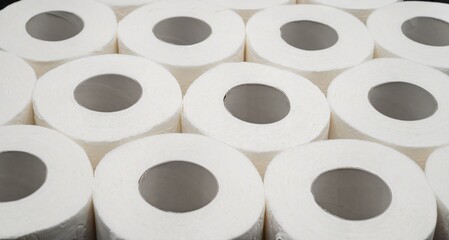 Stack of White Toilet Paper Rolls on Dark Surface &ndash; Clean and Minimal Style. Hygiene and Supply Concept