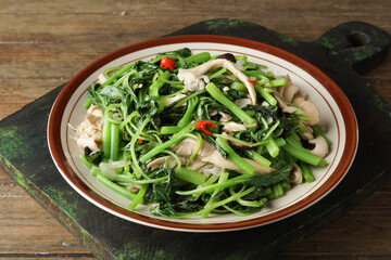 Close Up of Stir-Fried Spinach with Garlic Served on Rustic Plate as a Healthy Green Dish