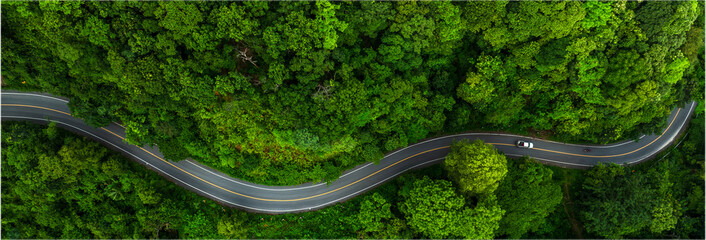 Road in the middle of the forest , road curve construction up to mountain, Rainforest ecosystem and healthy environment concept	