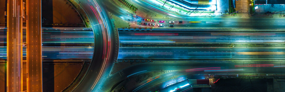 Expressway top view, Road traffic an important infrastructure, car traffic transportation above intersection road in city night, aerial view cityscape of advanced innovation, financial technology