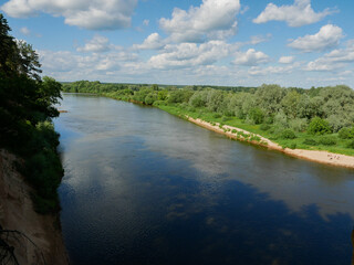 Simple European village landscape with a river.