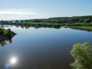 Simple European village landscape with a river.