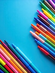 Fototapeta premium Colorful markers with vibrant colors scattered on a clean blue background