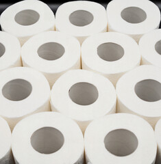 Stack of White Toilet Paper Rolls on Dark Surface – Clean and Minimal Style. Hygiene and Supply...
